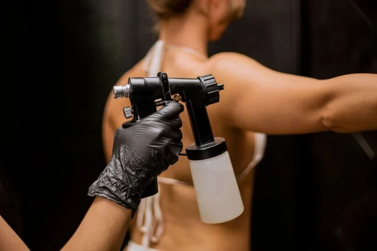 A woman getting tanned using spray tan technique