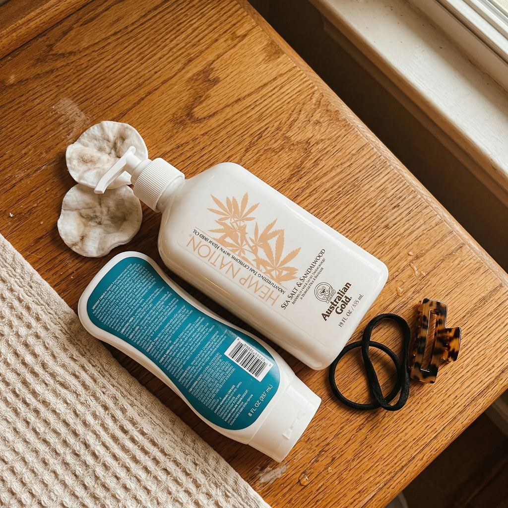 Australian Gold and Hemp Nation tan extender bottles on wooden surface